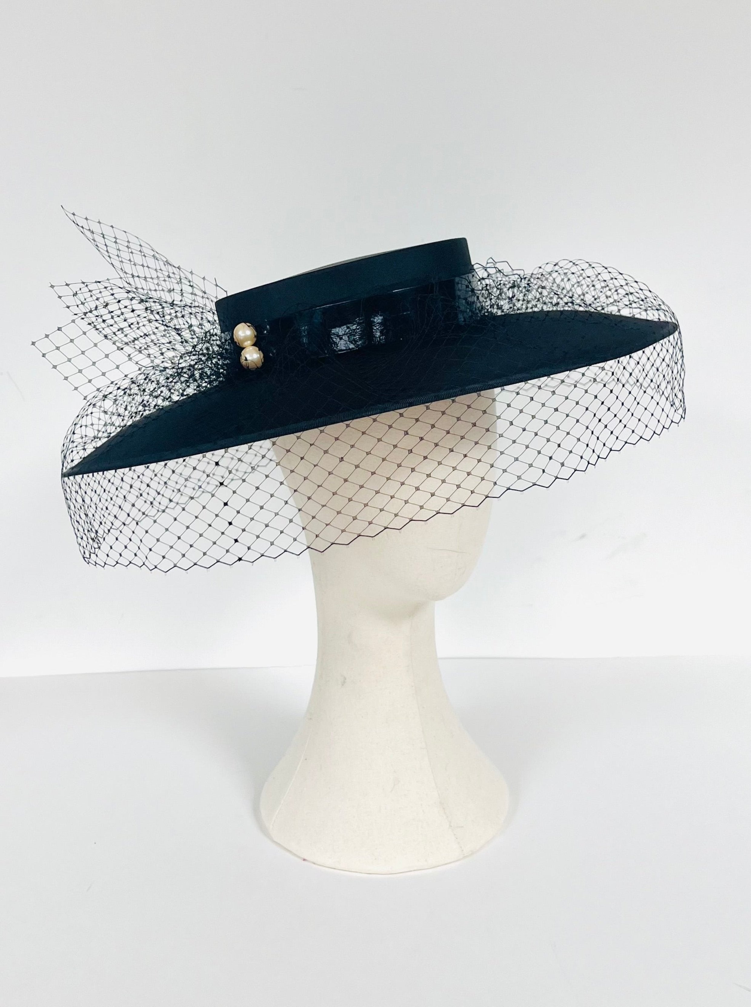 wide brimmed black satin boater hat with veiling netting